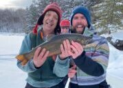 Friends holding up fishing catch